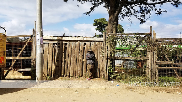 Narok Streets - Man on Fence Lean